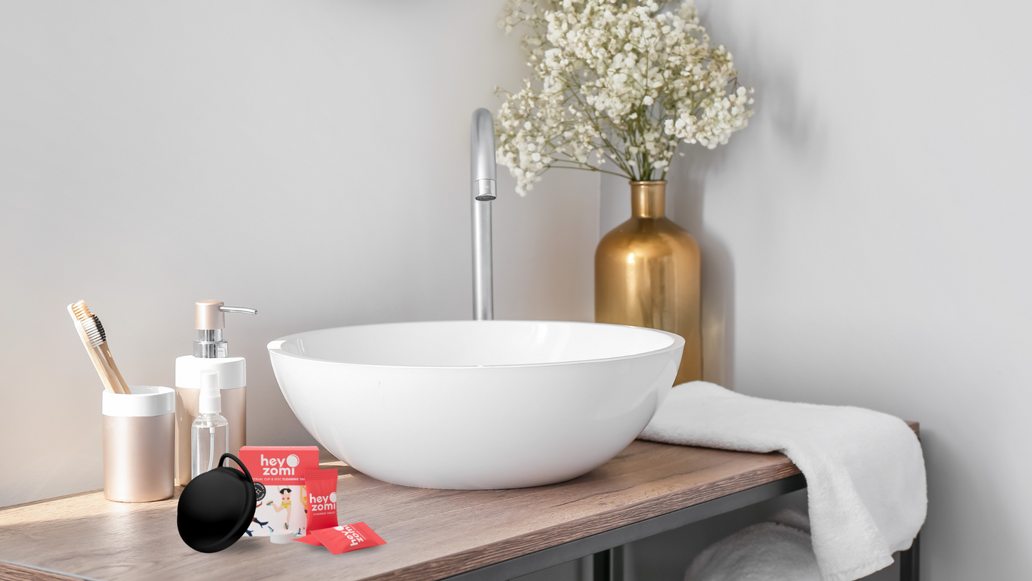 Hey Zomi Cleaning Tablets and reusable menstrual disc on a bathroom sink — easy, safe way to clean and sanitise your period disc without boiling.